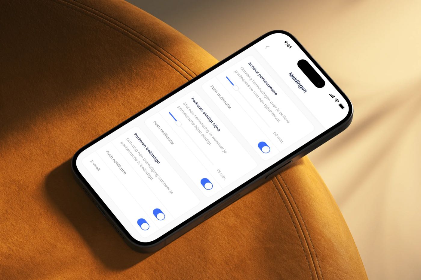 A phone on an orange armchair showing the notification settings