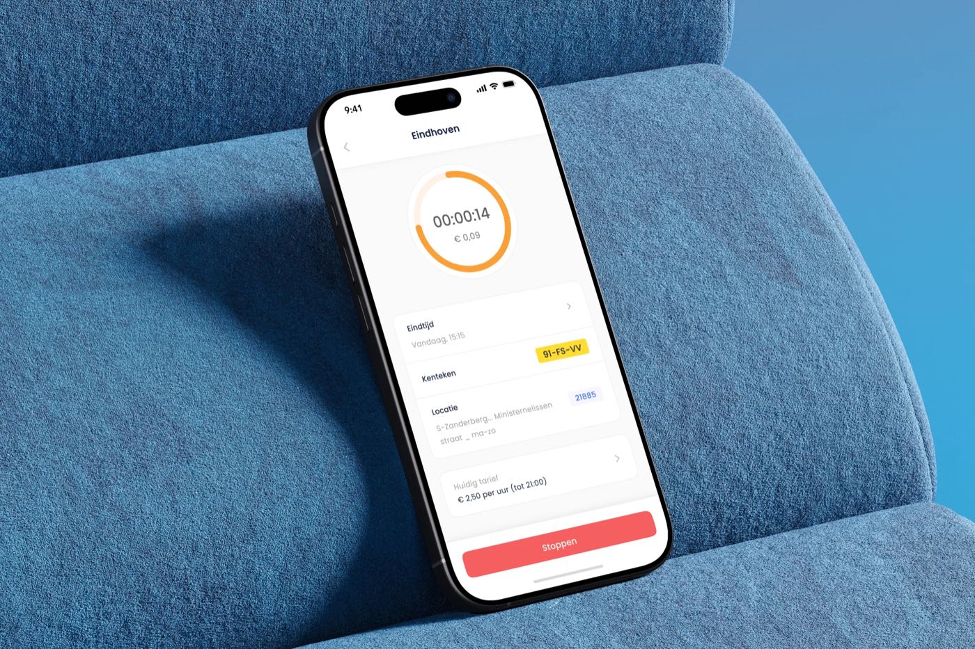 A phone on a blue sofa showing a running parking action